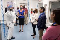 Rep. Ruiz listening to presentation from main in protective suit