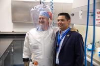 Rep. Ruiz posing with man in protective suit